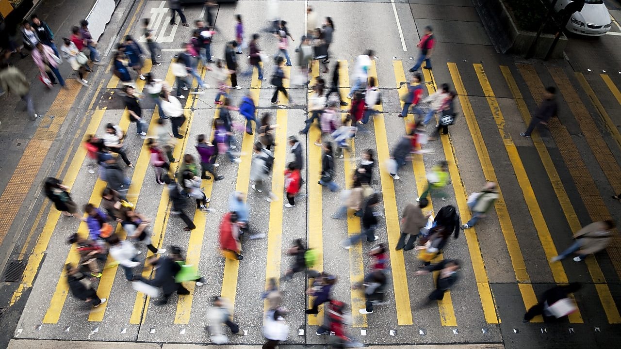 People crossing a busy street in Hong Kong