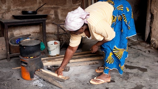 Lady cooking on a cookstove in Nigeria