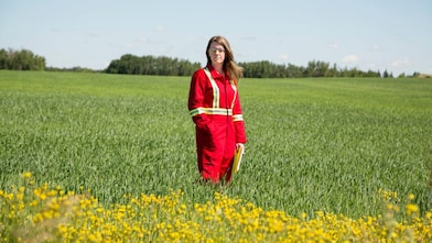 An employee stands in a field near a Quest C02 injection well northeast of Edmonton, Alberta in Canada